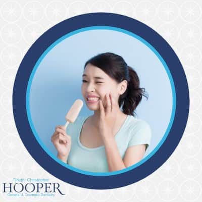 Woman with sensitive teeth eating ice cream
